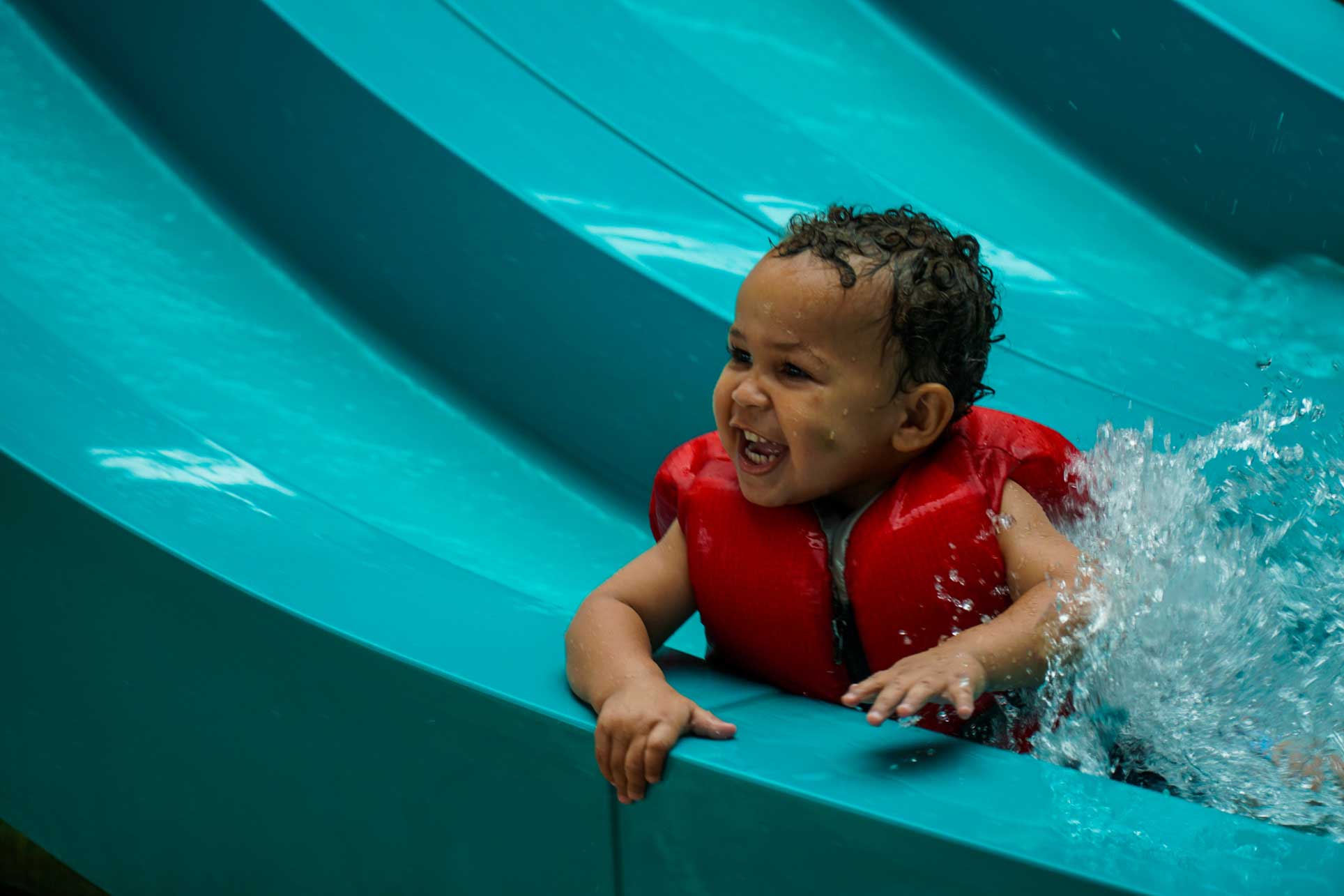 Soaring Eagle baby smiling on slide