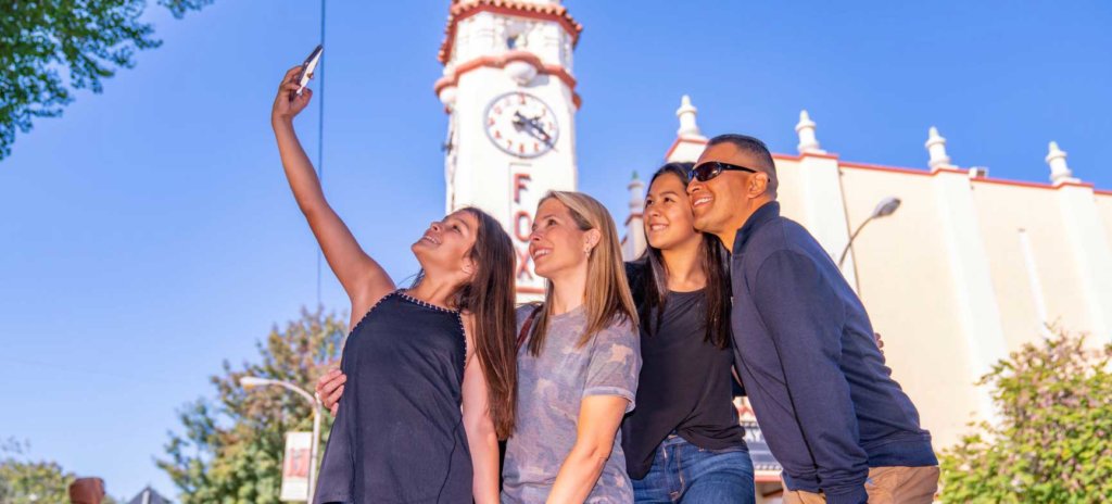 Visit Visalia family of four taking selfie in front of Fox Theatre