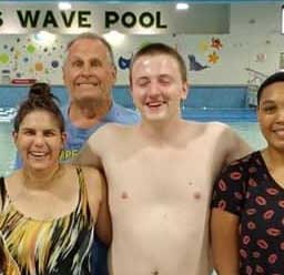 group of swimmers smiling at the Kiwanis Rec Pool
