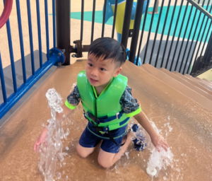 young boy in splash pad area